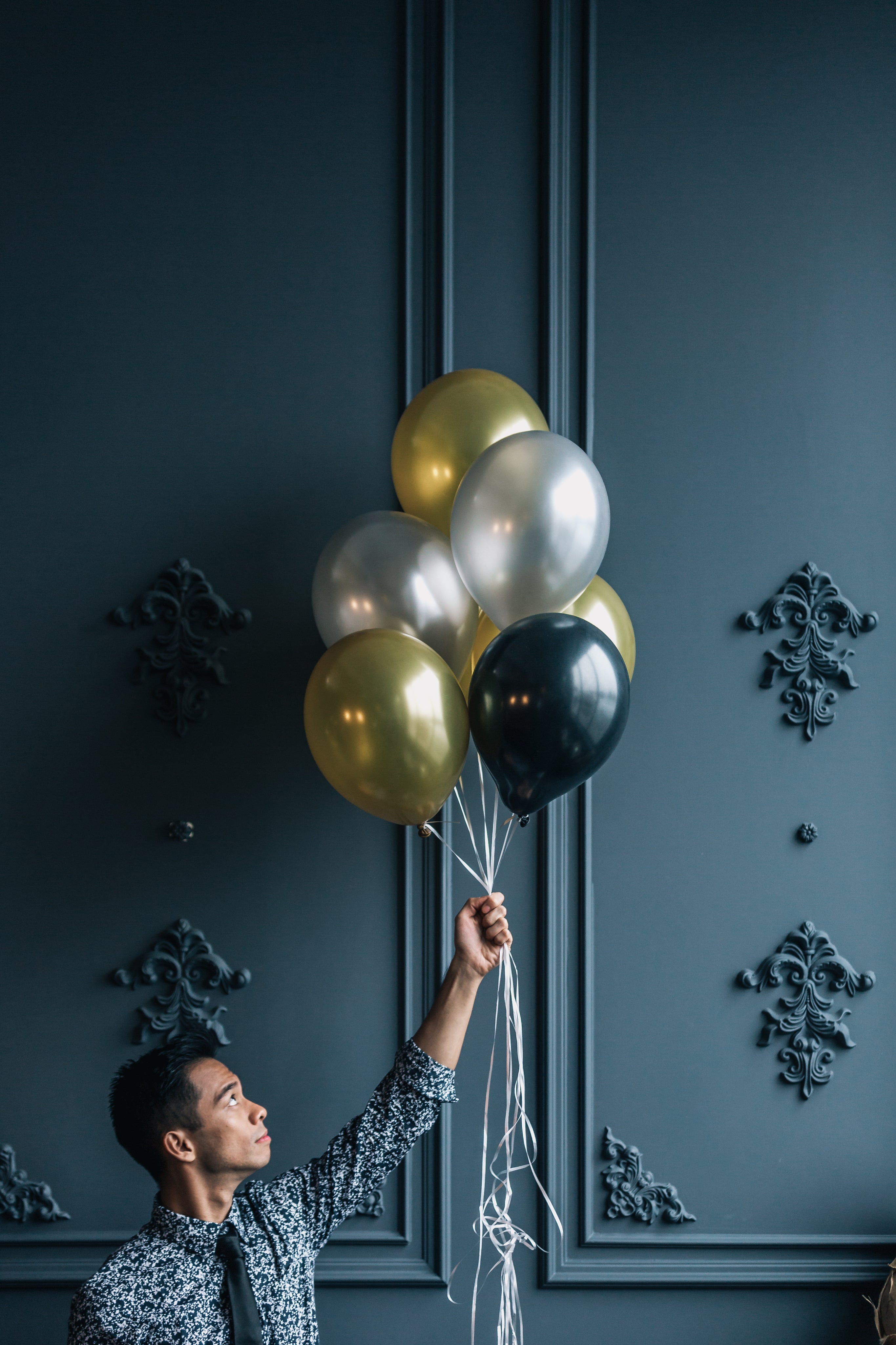 man-holding-party-balloons.jpg